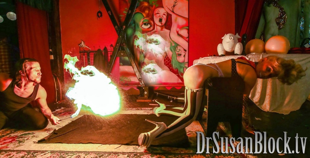 Dark Phoenix gives Dr. Suzy a bday fire spanking.  Photo: JuxLii